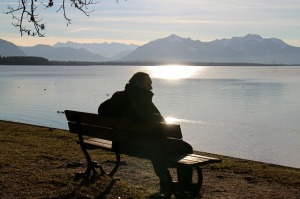 Man sitting on a bench looking at the water
