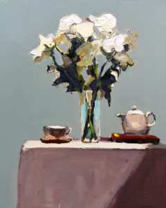 White flowers iin vase on table with teapot and cup