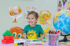Smiling child with art supplies