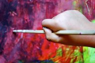 hand of a child painting vibrant colors 