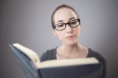 Woman reading a large book