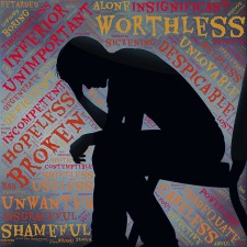 silhouette of dejected man sitting with head on his hand with a background of words such as worthless, unwanted, hopeless, etc.