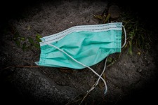 discarded turquoise surgical mask