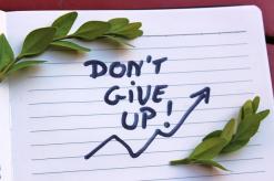 laurel leaves on top and bottom of the words "Dont Give Up!" written with marker in a journal 