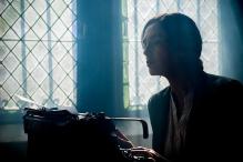 Writer working at an old-fashioned typerwriter in front of a window