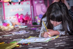 Colorful photo of young girl working on artwork