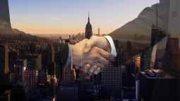 Two people shaking hands with a background of a city skyline
